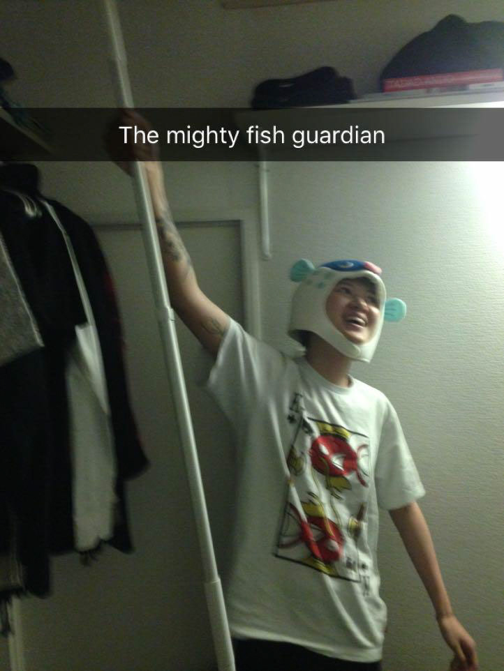 me the mighty fish guardian wearing a fish themed ensemble holding a up a lint roller staff