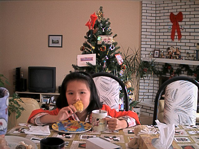 me as an eight year old wearing a house coat with my elbows on the table eating fried chicken while holding a clefairy mug