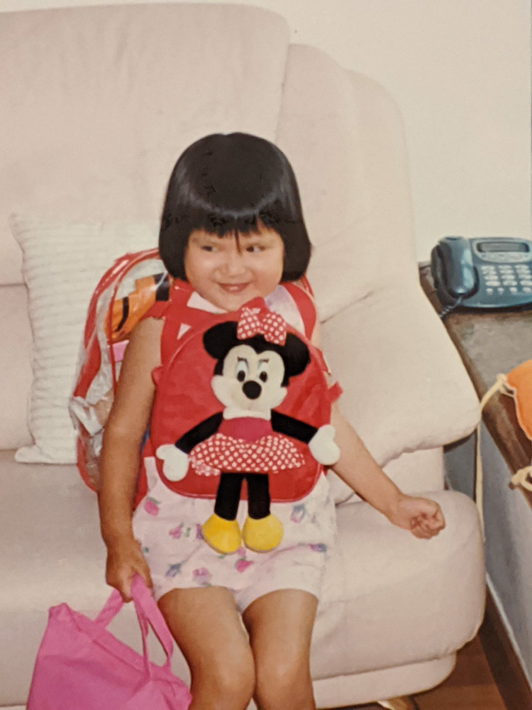 me as a five year old with a bowl cut and several backpacks on, making a mischevous expression